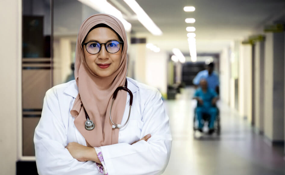 Female medical professional standing in corridor